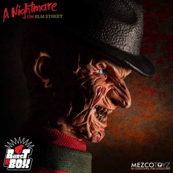 Mezco’s Burst-A-Box is a pop culture infused twist on one of the most beloved, classic toys, the jack-in-the-box. The A Nightmare on Elm Street Burst-A-Box features Freddy Krueger – the dream-haunting Elm Street slasher. This fully functioning jack-in-the-box is approximately 14” tall when “popped”. The Burst-A-Box features a detailed head sculpt and a clothed spring body, all encased in a tin music box. Designed after his appearance in the film, Freddy features a devilish grin and wears his infamous striped sweater with a removable fedora that he can wear when popped out of his tin. Burst-A-Box A Nightmare on Elm Street: Freddy Krueger comes packaged popped-out of his tin and perfect for display in a collector-friendly window box.